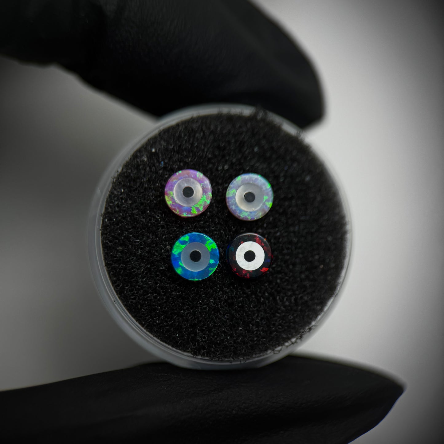 Opal dental gem in the shape of an evil eye